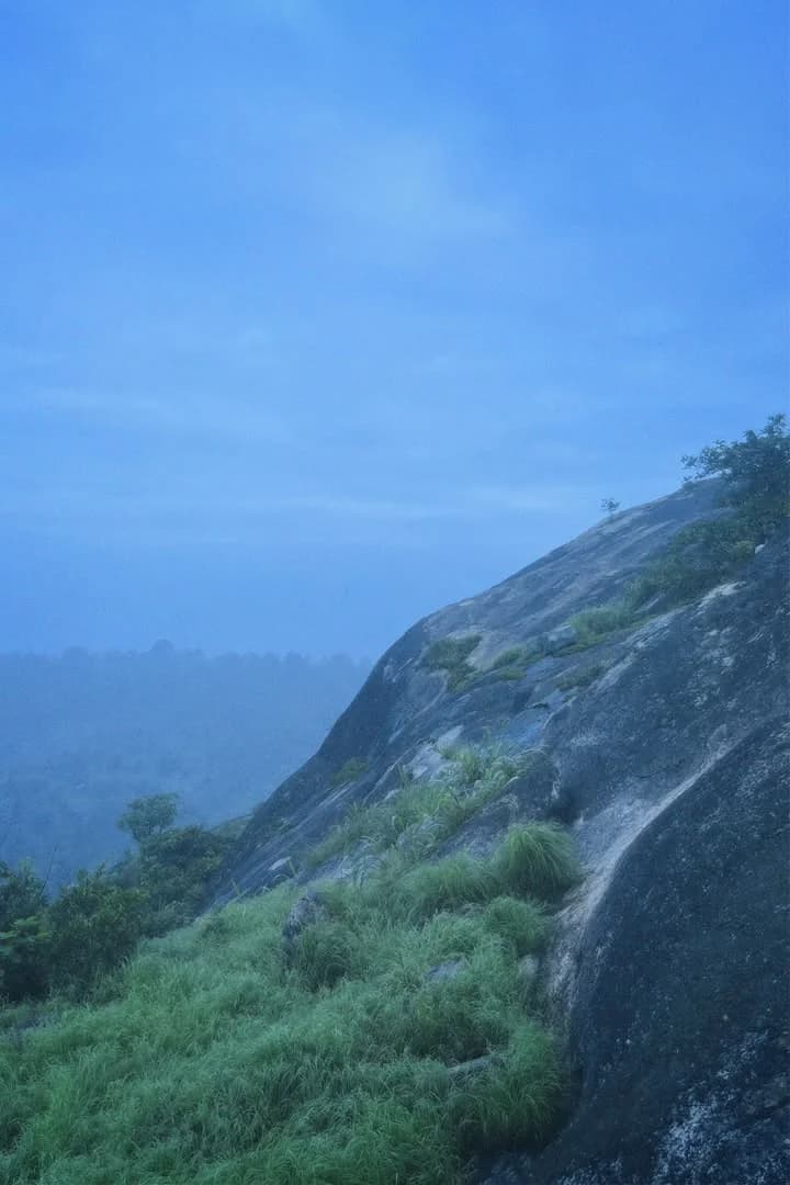 Steep rock face against blue sky